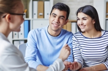 Happy Young Couple Making Deal With Realtor