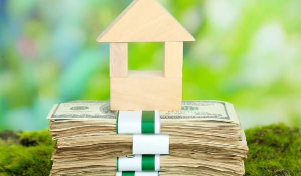 Wooden Block House On Money.jpg